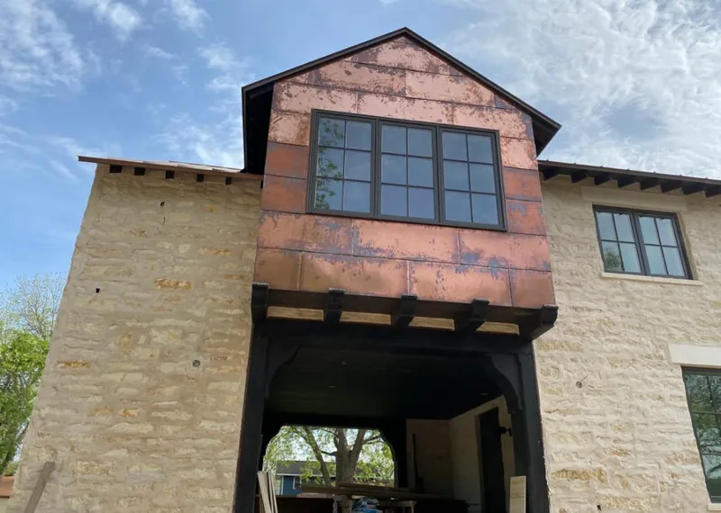Copper metal panel facade on a stone building for Skylight Installation in Brownstown
